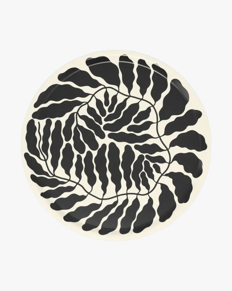 Round serving tray with charcoal leaf motif by Linnéa Andersson for Wrap