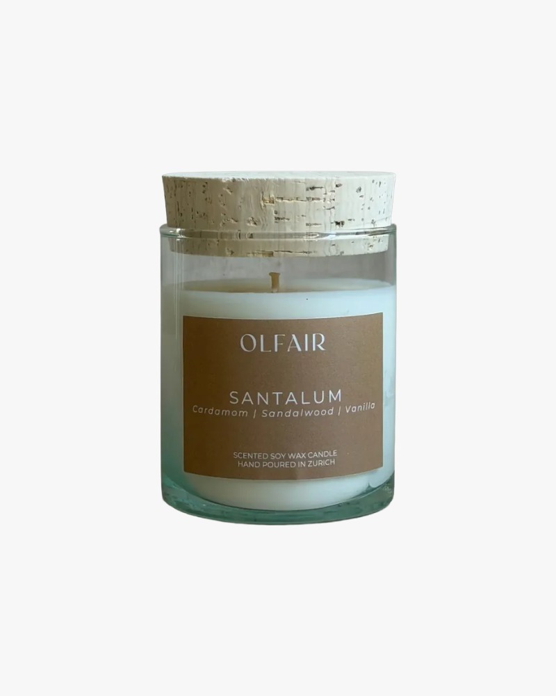 Santalum scented candle by Olfair in a clear glass with cork lid, warm sandalwood fragrance handmade in Zürich