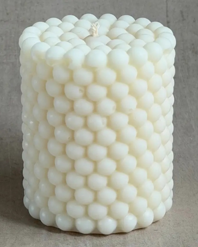 Bubbles cylinder candle by Olfair with raised spherical relief texture, handmade in Zürich from natural olive wax
