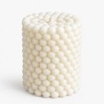 Bubbles cylinder candle by Olfair with raised spherical relief texture, handmade in Zürich from natural olive wax